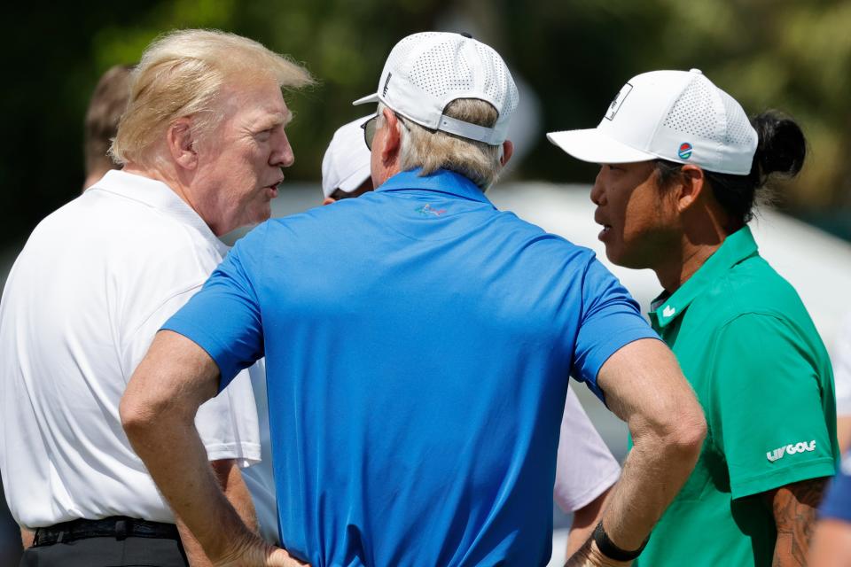 Apr 7, 2024; Miami, Florida, USA;Donald Trump, left, greets Anthony Kim a wildcard, right, as Greg Norman listens in before the final round of LIV Golf Miami golf tournament at Trump National Doral. Mandatory Credit: Reinhold Matay-USA TODAY Sports