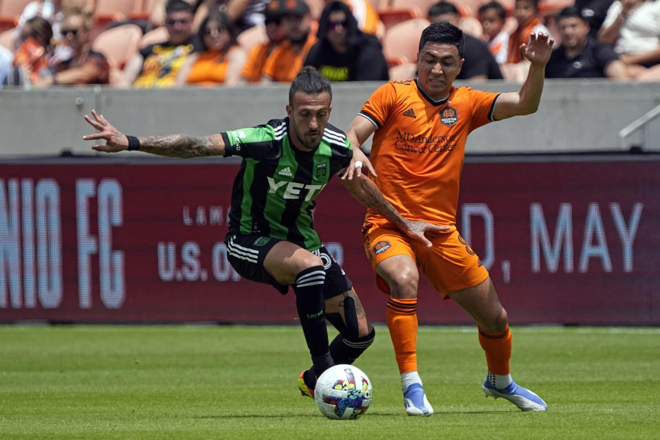 Houston Dynamo's Memo Rodríguez (8) challenges Austin FC's Maximiliano Urruti (37) for the ball during the second half of a MLS soccer match Saturday, April 30, 2022, in Houston. Austin FC won 2-1. (AP Photo/David J. Phillip)