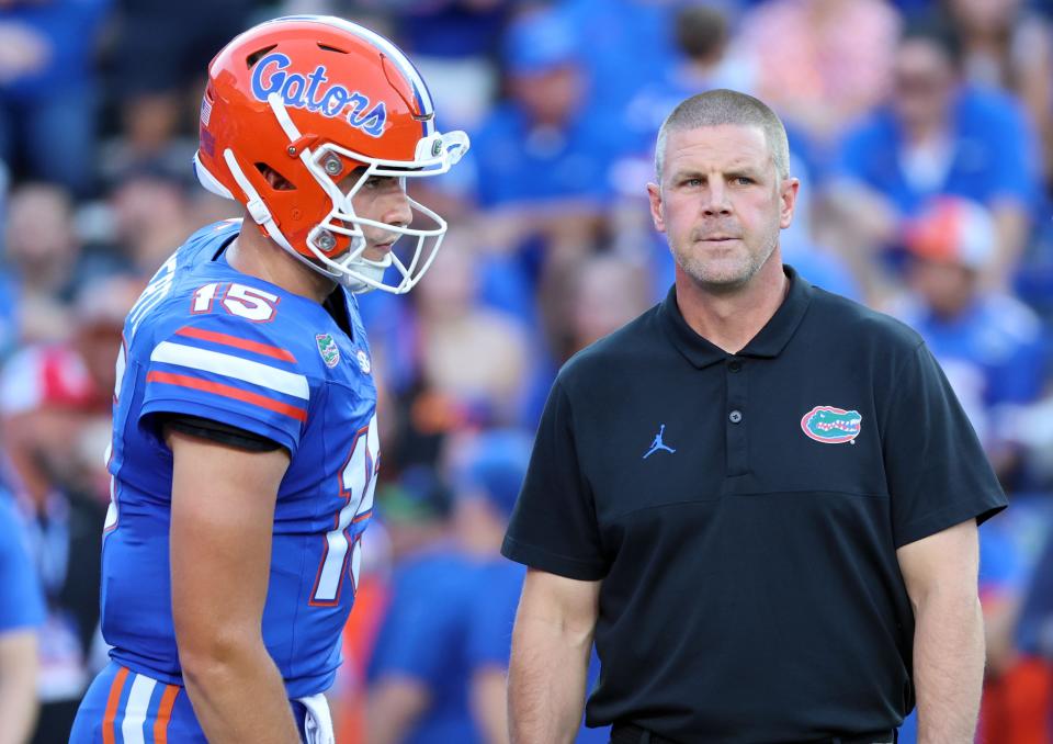 Florida quarterback Graham Mertz (15) and head coach Billy Napier prior to a game against the Tennessee Volunteers, Sept. 16, 2023, at Ben Hill Griffin Stadium.