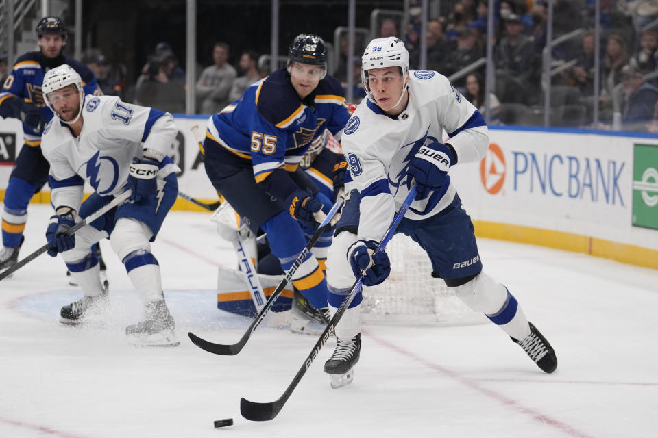 Tampa Bay Lightning's Waltteri Merela (39) passes as St. Louis Blues' Colton Parayko (55) defends during the first period of an NHL hockey game Tuesday, Nov. 14, 2023, in St. Louis. (AP Photo/Jeff Roberson)