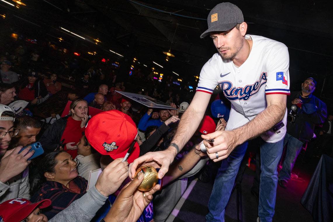 Texas Rangers pitcher Andrew Heaney signs memorabilia with fans during a Rangers World Series celebration event at Billy Bob’s Texas in Fort Worth on Thursday, Nov. 9, 2023. Chris Torres/ctorres@star-telegram.com