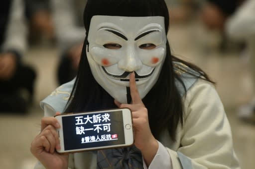 ?Five demands, not one rest? is the message shown on a mobile phone during a protest in Hong Kong