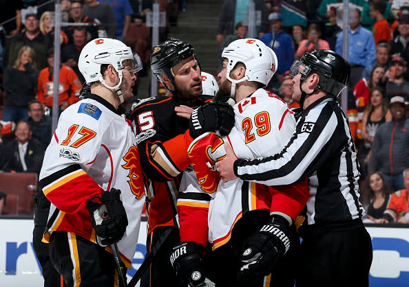 ANAHEIM, CA - APRIL 4: Ryan Getzlaf #15 of the Anaheim Ducks is separated from Lance Bouma #17 and Deryk Engelland #29 of the Calgary Flames by linesman Trent Knorr #63 during the third period of the game at Honda Center on April 4, 2017 in Anaheim, California. (Photo by Debora Robinson/NHLI via Getty Images) ***Local Caption ***