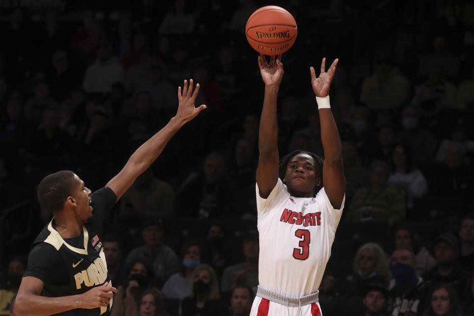 North Carolina State's Cam Hayes (3) shoots against Purdue's Isaiah Thompson during the first half of an NCAA college basketball game Sunday, Dec. 12, 2021, in New York. (AP Photo/Jason DeCrow)