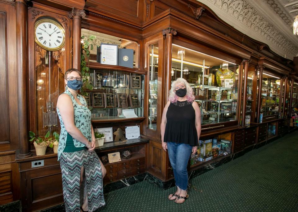 The Gameboard's Lynn Potyen, left, and store manager Caitlin Bramm  pose inside the store where many of their awards and accolades are displayed, Thursday, July 14, 2022, in Sheboygan, Wis.