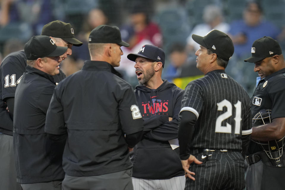 Minnesota Twins manager Rocco Baldelli, third from right, talks with umpires and Chicago White Sox manager Pedro Grifol (21) before a baseball game Friday, Sept. 15, 2023, in Chicago. (AP Photo/Erin Hooley)