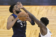 Minnesota Timberwolves center Karl-Anthony Towns (32) is fouled by Orlando Magic center Mo Bamba (5) during the first half of an NBA basketball game Sunday, May 9, 2021, in Orlando, Fla. (AP Photo/Phelan M. Ebenhack)