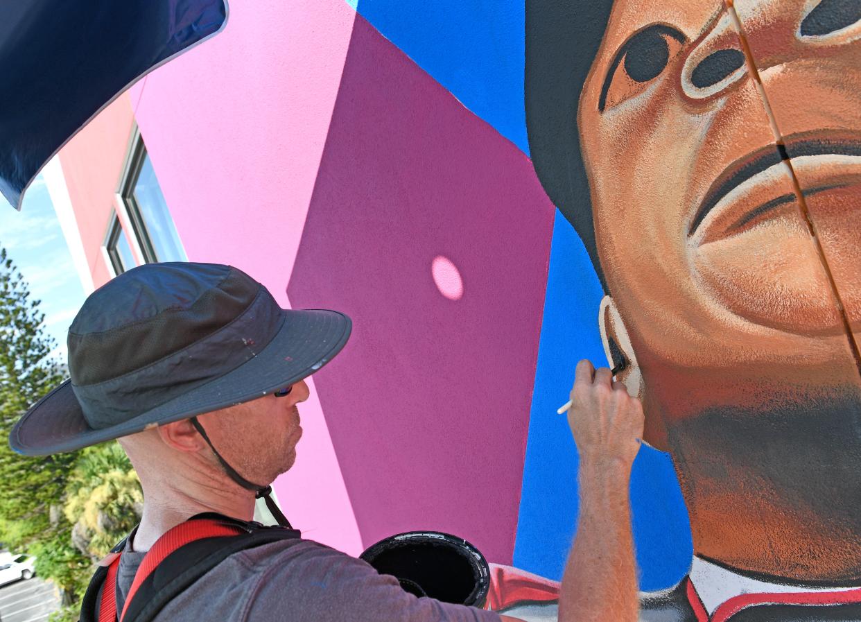 Sarasota artist Matt McAllister works on his mural of Buck O'Neil.