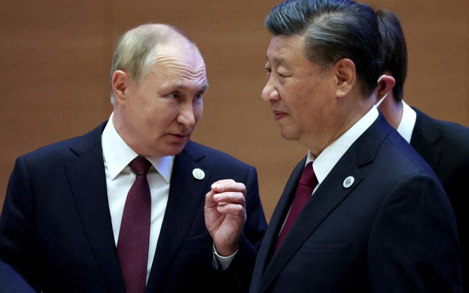 Russian President Vladimir Putin speaks with Chinese President Xi Jinping