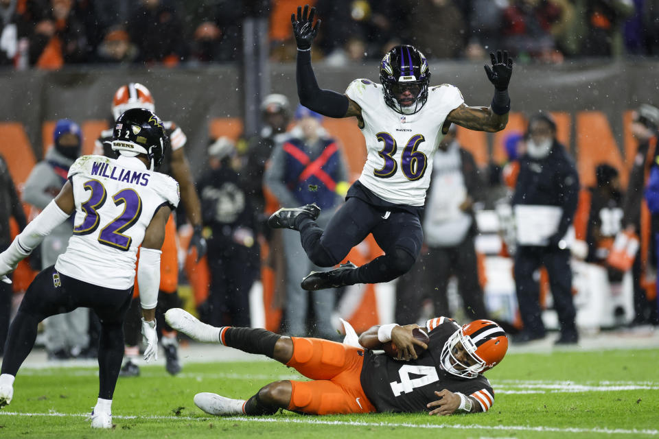 Baltimore Ravens safety Chuck Clark (36) jumps over Cleveland Browns quarterback Deshaun Watson during the second half of an NFL football game, Saturday, Dec. 17, 2022, in Cleveland. (AP Photo/Ron Schwane)