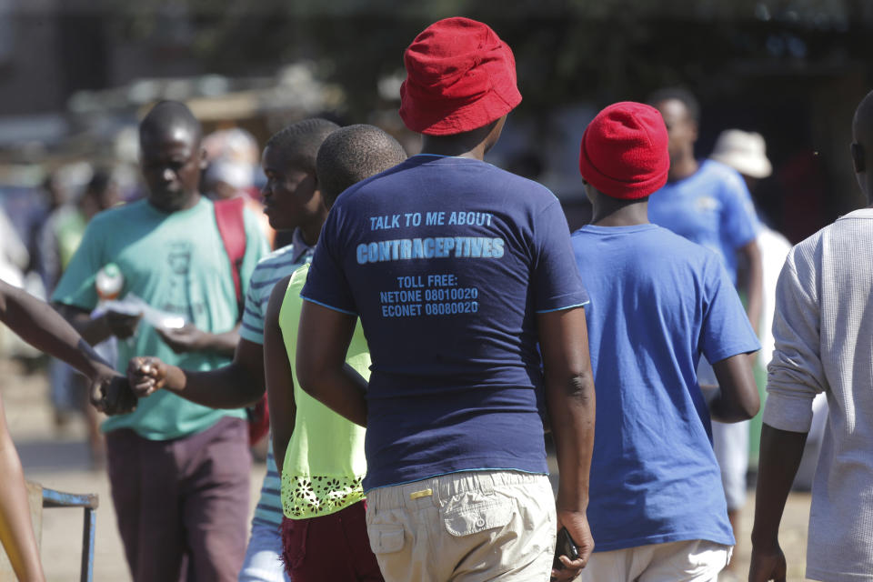 In this Tuesday, April 7, 2020 photo, a man wears a T- shirt with an advertisement regarding contraceptives, in Harare. Lockdowns imposed to curb the coronavirus’ spread have put millions of women in Africa, Asia and elsewhere out of reach of birth control and other sexual and reproductive health needs. Confined to their homes with husbands and others, they face unwanted pregnancies and little idea of when they can reach the outside world again. (AP Photo/Tsvangirayi Mukwazhi)