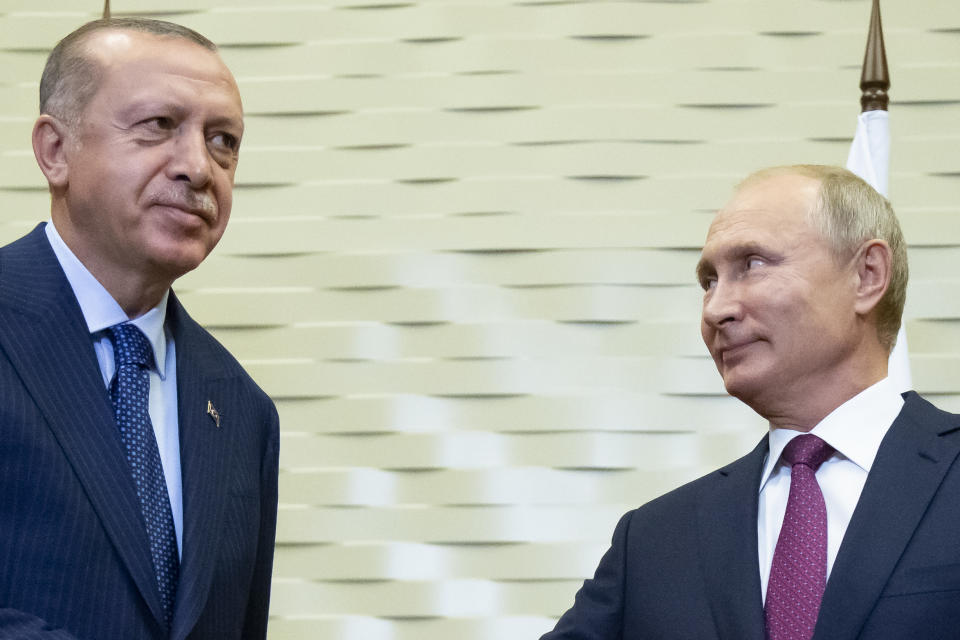 Russian President Vladimir Putin, right, and Turkish President Recep Tayyip Erdogan greet each other during their meeting in the Bocharov Ruchei residence in the Black Sea resort of Sochi in Sochi, Russia, Monday, Sept. 17, 2018. The presidents of Russia and Turkey are meeting in the Russian Black Sea resort of Sochi on Monday in a bid to find a diplomatic resolution to the crisis around a rebel-held region in Syria. (AP Photo/Alexander Zemlianichenko, Pool)