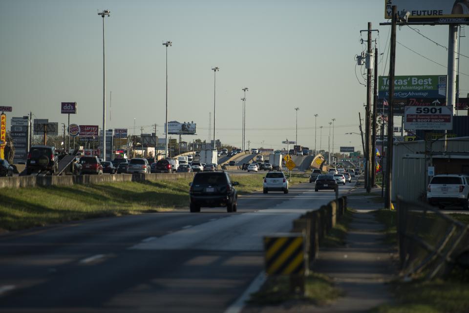 Traffic flows south on Interstate 45 and the frontage road in the afternoon Friday, Nov. 19, 2021, in Houston. A $9 billion highway widening project being proposed in the Houston area could become an important test of the Biden administration’s commitment to addressing what it says is a history of racial inequity with infrastructure projects. (AP Photo/Justin Rex)