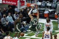 Milwaukee Bucks' Giannis Antetokounmpo (34) dunks during the first half of Game 3 of basketball's NBA Finals against the Phoenix Suns in Milwaukee, Sunday, July 11, 2021. (AP Photo/Paul Sancya)