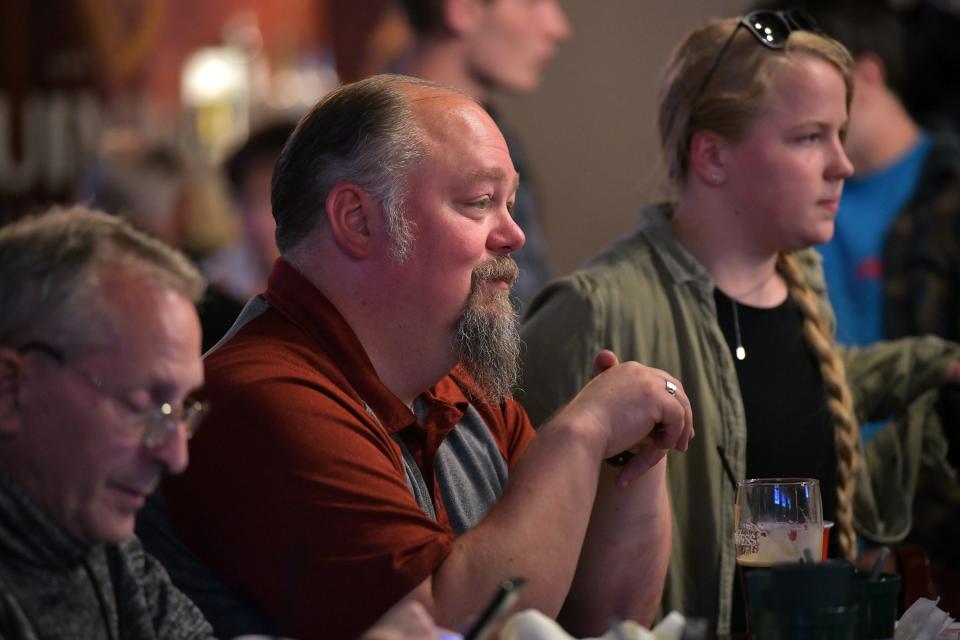 Kenneth Biel, center, a Ron DeSantis supporter from Chester, NH, was among the potential voters watch the first Republican presidential debate at Murphy's Taproom in Manchester, N.H. on Aug 23, 2023.