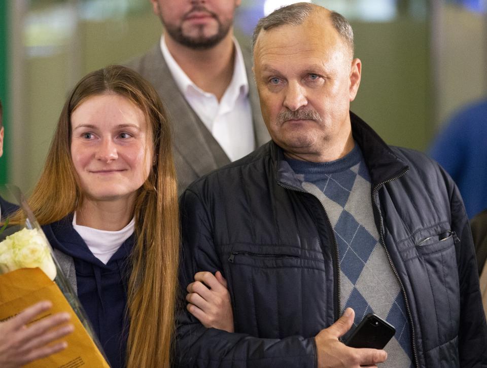 Russian agent Maria Butina, and her father Valery walk upon her arrival from the United States at Moscow International Airport Sheremetyevo outside Moscow Moscow, Russia, Saturday, Oct. 26, 2019. Butina, a gun rights activist who sought to infiltrate conservative U.S. political groups and promote Russia's agenda around the time that Donald Trump rose to power, was released Friday from a low-security facility in Florida. (AP Photo/Alexander Zemlianichenko)