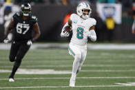 Miami Dolphins safety Jevon Holland (8) runs an interception back for a touchdown against the New York Jets during the second quarter of an NFL football game, Friday, Nov. 24, 2023, in East Rutherford, N.J. (AP Photo/Noah K. Murray)