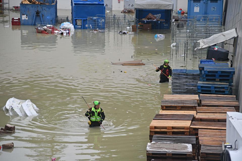 Speleological alpine rescuers search for missing persons in a flooded area near a supermarket in Cesena on May 17, 2023. Heavy rains have caused major flooding in central Italy, where trains were stopped and schools were closed in many towns while people were asked to leave the ground floors of their homes and to avoid going out.