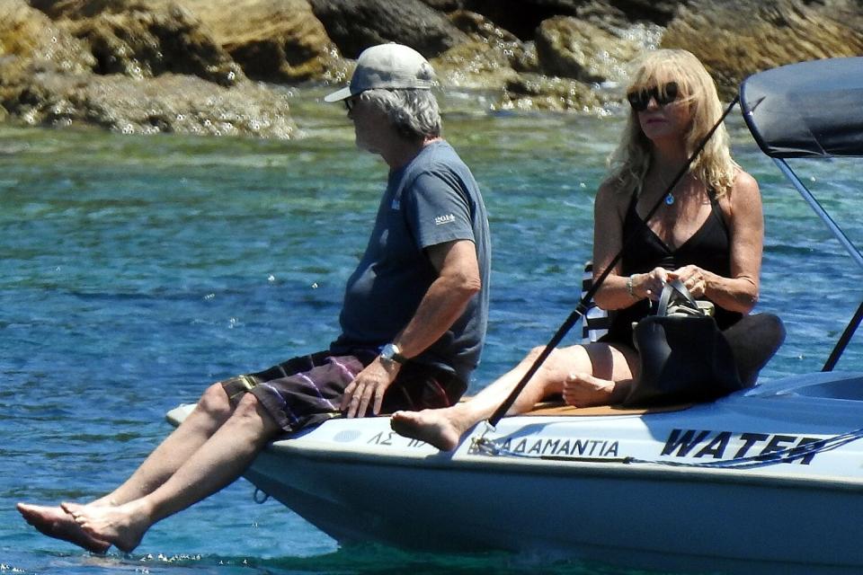 Kurt Russell and Goldie Hawn spotted to go on a speed boat at Skiathos Island. Goldie Hawn seen very happy wearing a black dress.