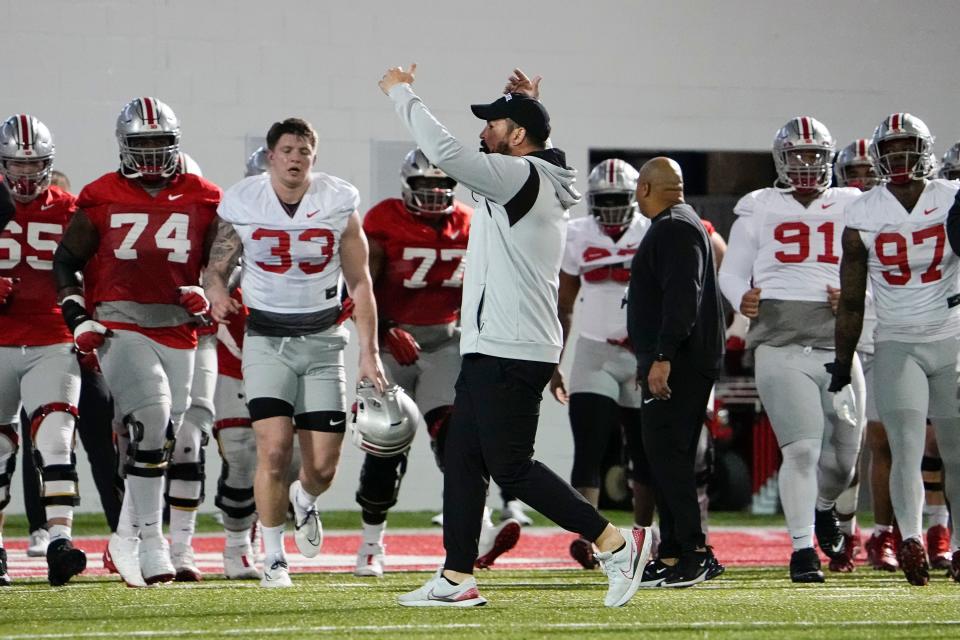 Mar 7, 2023; Columbus, Ohio, USA;  Ohio State Buckeyes head coach Ryan Day gathers his team for a huddle at the start of spring football drills at the Woody Hayes Athletic Center. Mandatory Credit: Adam Cairns-The Columbus Dispatch