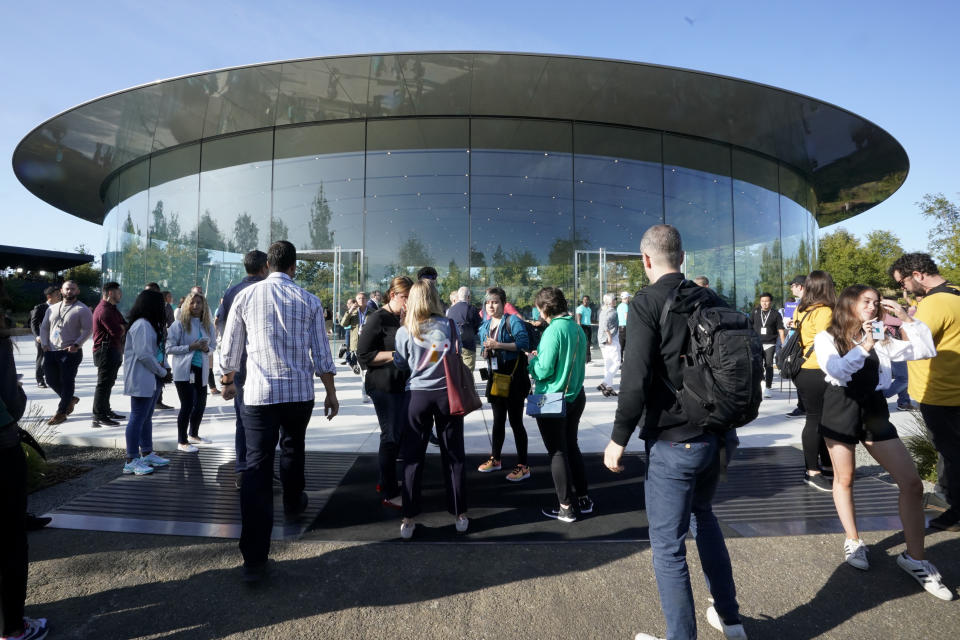 People arrive at Apple for an event to announce new products Tuesday, Sept. 10, 2019, in Cupertino, Calif. (AP Photo/Tony Avelar)