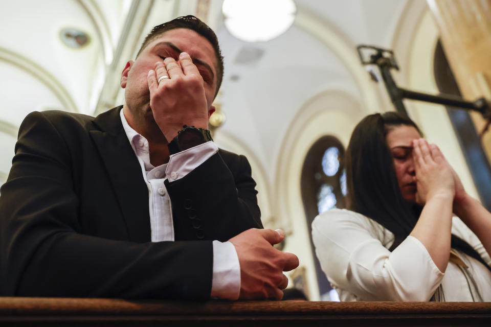 Parishioners pray during Easter Mass at Sacred Heart of Jesus and Saint Patrick, Sunday, March 31, 2024, in Baltimore, Md. (AP Photo/Julia Nikhinson)