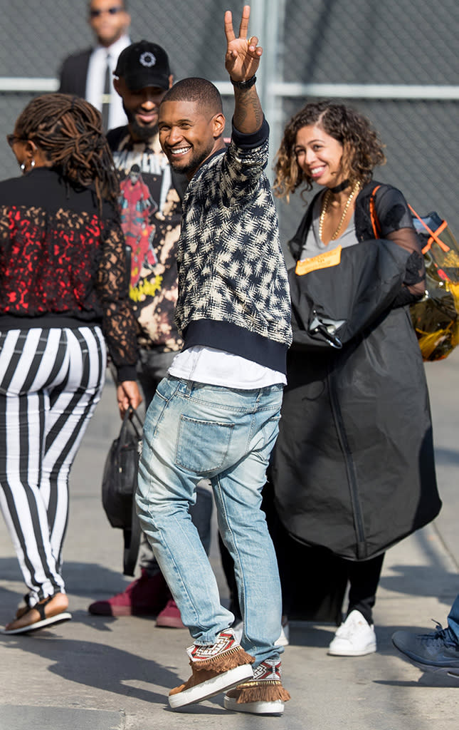 For comparison purposes, Usher, here on his way to make a guest appearance on <em>Jimmy Kimmel Live</em>, doesn’t usually try to fly under the radar when he’s out and about. (Photo: Backgrid)