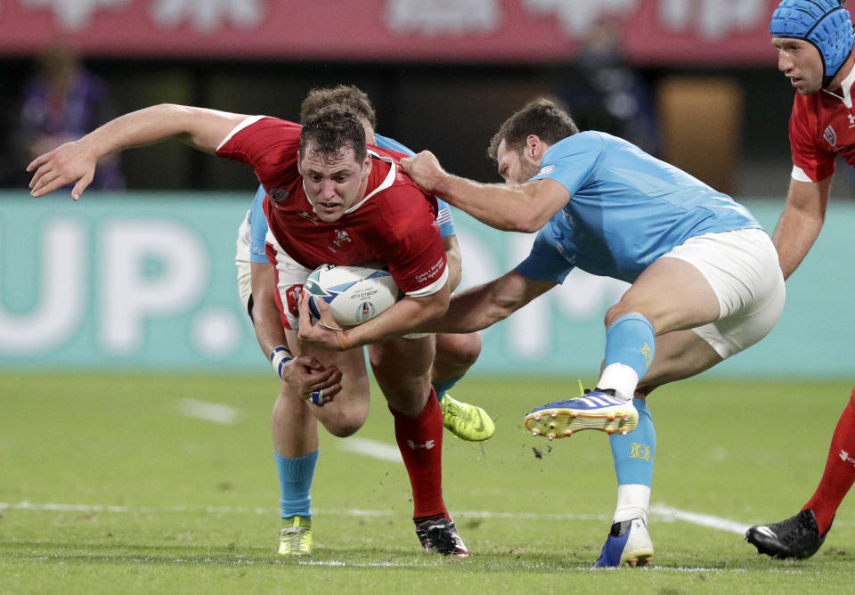 Wales' Ryan Elias is tackled during the Rugby World Cup Pool D game at Kumamoto Stadium between Wales and Uruguay in Kumamoto, Japan, Sunday, Oct. 13, 2019. (AP Photo/Aaron Favila)