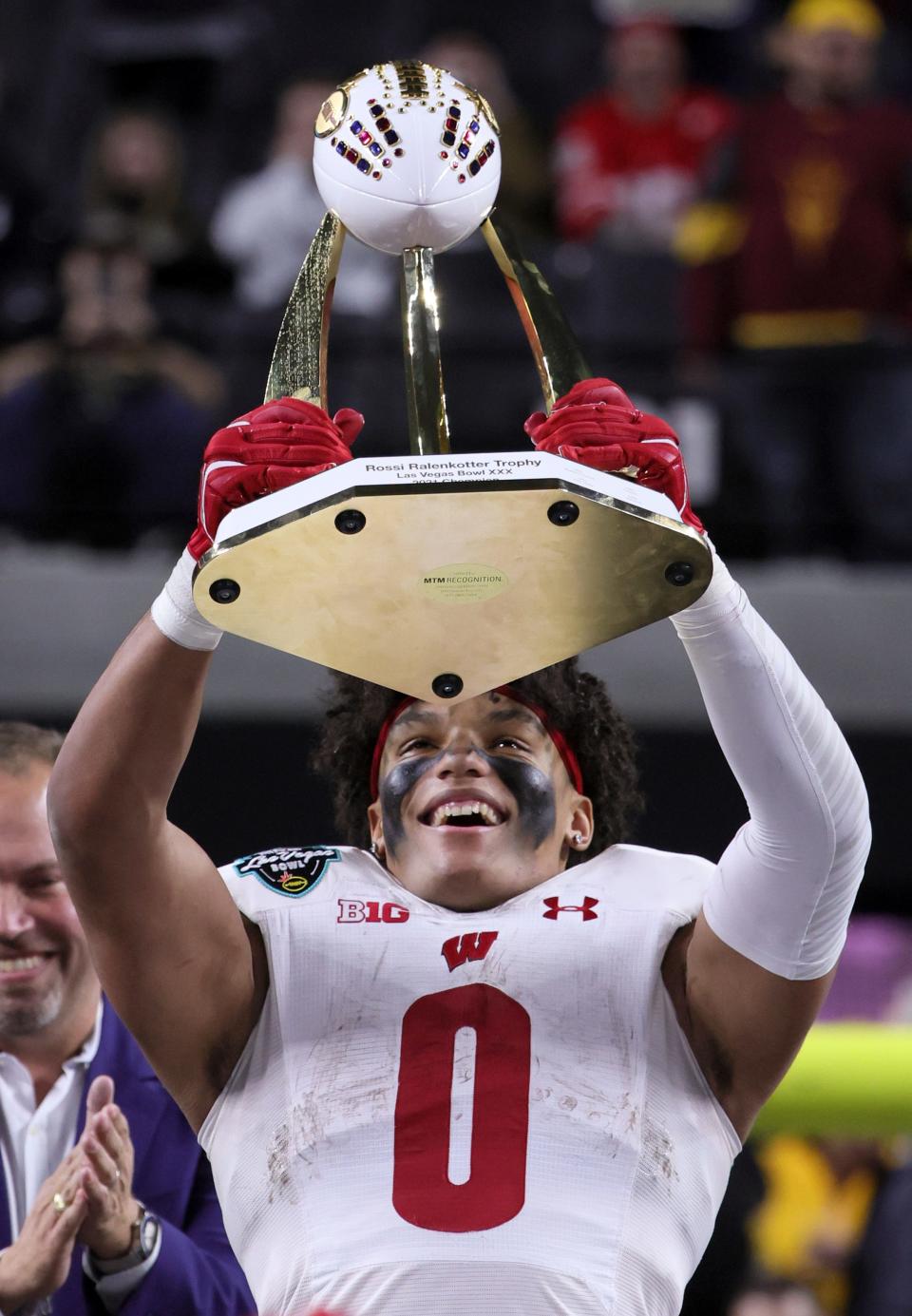 Wisconsin freshman Braelon Allen holds the championship trophy after rushing for 159 yards on 29 carries in a 20-13 victory over Arizona State in the 2021 Las Vegas Bowl.