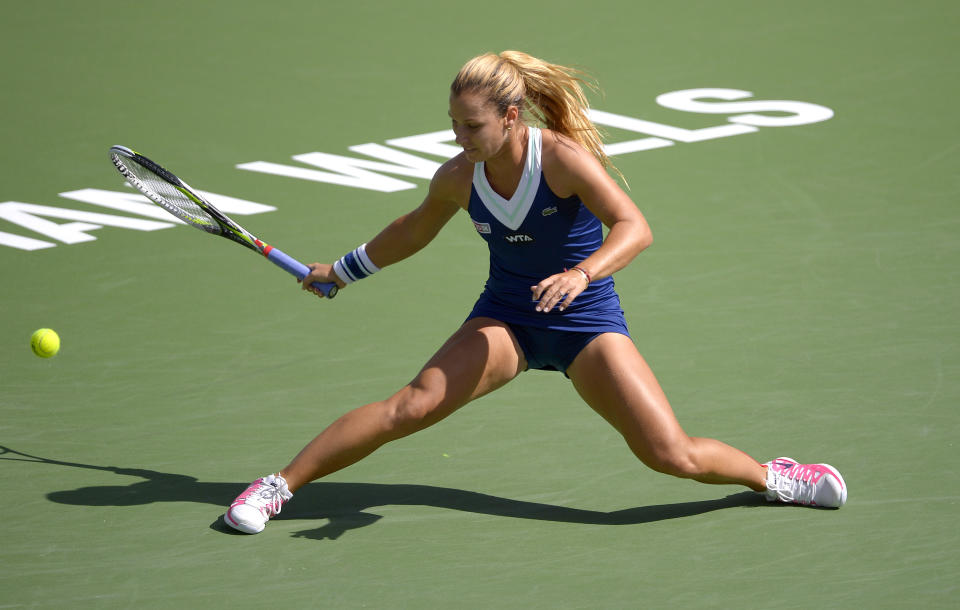 Dominika Cibulkova, of Slovakia, reaches for a hit from Li Na, of China, during a quarterfinal match at the BNP Paribas Open tennis tournament, Thursday, March 13, 2014 in Indian Wells, Calif. (AP Photo/Mark J. Terrill)