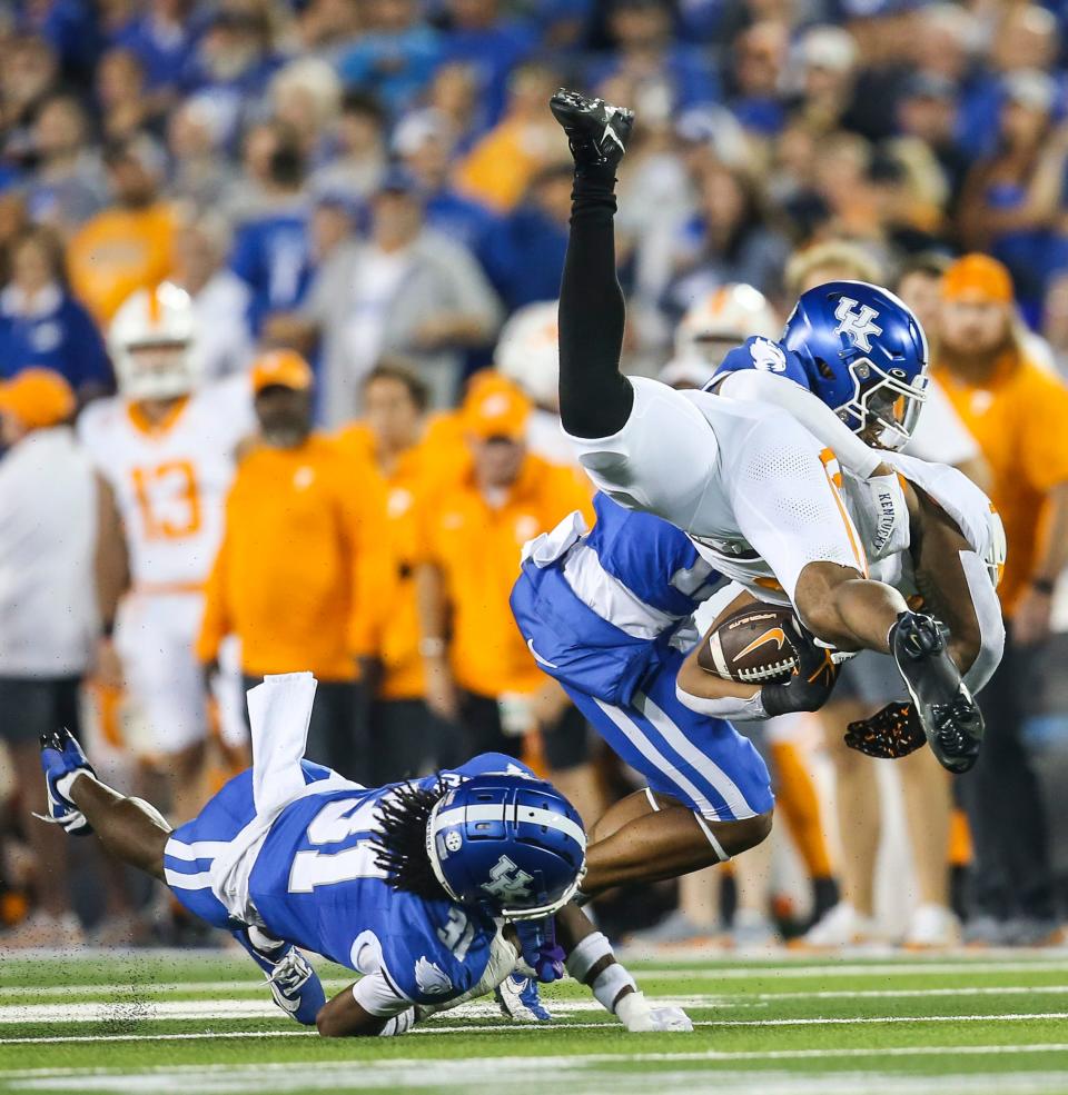 Kentucky defensive backs Maxwell Hairston (31) and Zion Childress stop Tennessee running back Jaylen Wright in the first half Saturday night.