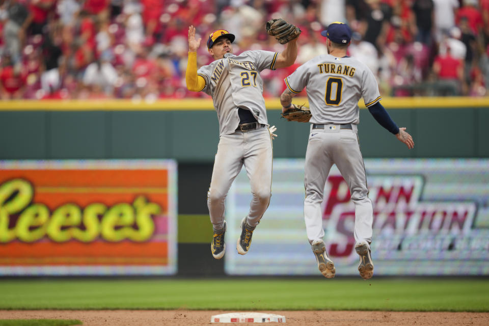 Milwaukee Brewers' Willy Adames, left, celebrates with Brice Turang after the final out of a baseball game against the Cincinnati Reds in Cincinnati, Sunday, July 16, 2023. (AP Photo/Aaron Doster)