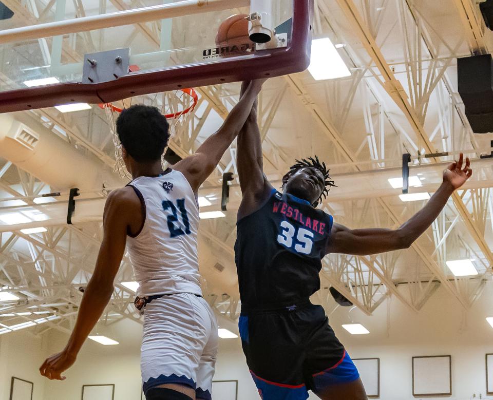Westlake Chaparrals center Wonder Kahozi (35) blocks the slam dunk attempt by Fort Bend Clements Rangers guard Rahman Olajuwon (21) during the second period at the William Roberts Memorial Tournament on Saturday, Dec 30, 2023, at Round Rock High School - Round Rock, TX.