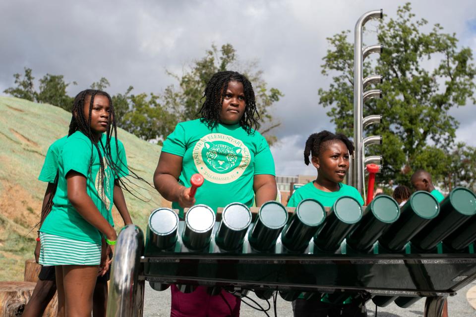 Pineview Elementary students play at the new Red Hills Rhythm musical parklet within Coal Chute Pond Park after its official opening ceremony Wednesday, July 13, 2022 in Tallahasse, Fla. 