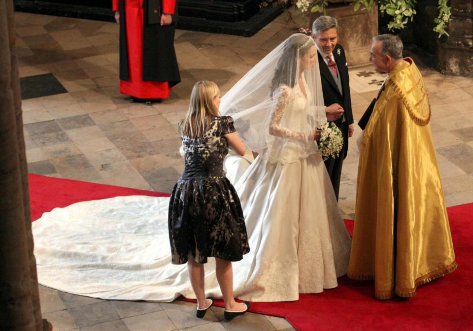Alexander McQueen Creative Director Sarah Burton adjusting Kate Middleton's wedding dress
