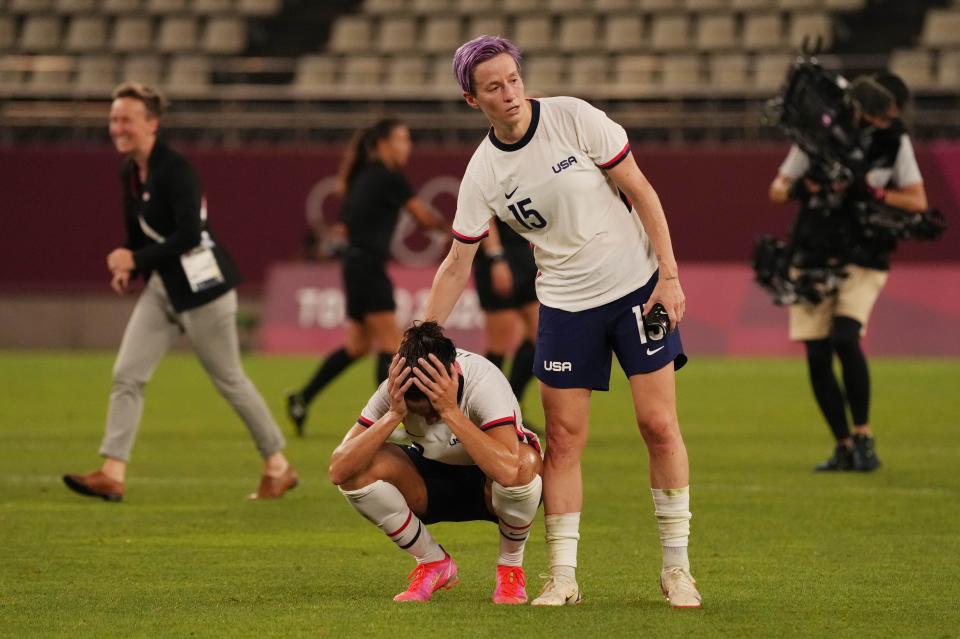 Forwards Carli Lloyd (10) and Megan Rapinoe (15) react after losing to Canada in a the semifinals of women's soccer at the Tokyo Olympics.