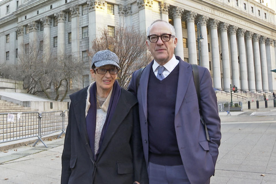 Kevin Maxwell and Isabel Maxwell stand in front of the federal courthouse where their sister Ghislaine Maxwell is on trial for sex trafficking in New York, on Friday, Dec. 3, 2021. The case against Maxwell stems from four now-adult women who said she recruited them into being sexually abused by Jeffrey Epstein. (AP Photo/Ted Shaffrey)