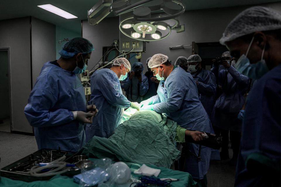 Surgeons operate on a patient in a surgery operating theater at the European Hospital in Khan Yunis in the southern Gaza Strip on Dec. 31, 2023 amid the ongoing conflict between Israel and the militant group Hamas.