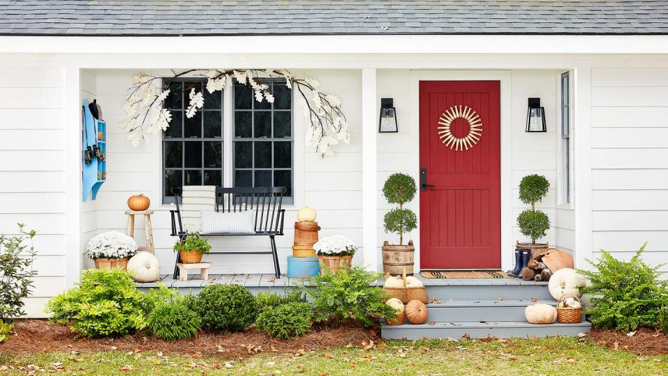 front door and porch decorated for fall