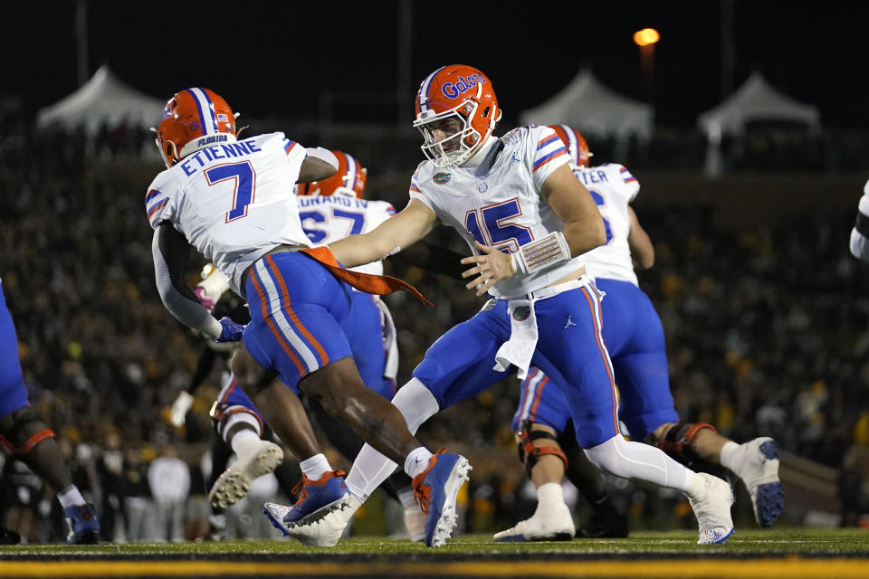 Florida quarterback Graham Mertz (15) hands off to running back Trevor Etienne (7) during the first half of an NCAA college football game against Missouri Saturday, Nov. 18, 2023, in Columbia, Mo. (AP Photo/Jeff Roberson)