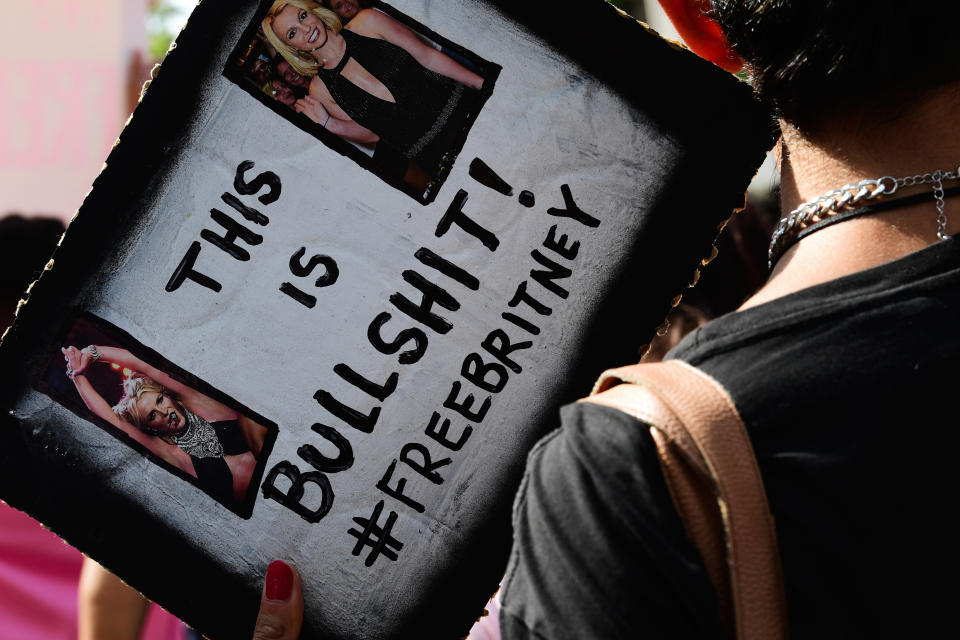 A person holding a flyer that says, ""This is Bullshit! #freebritney"