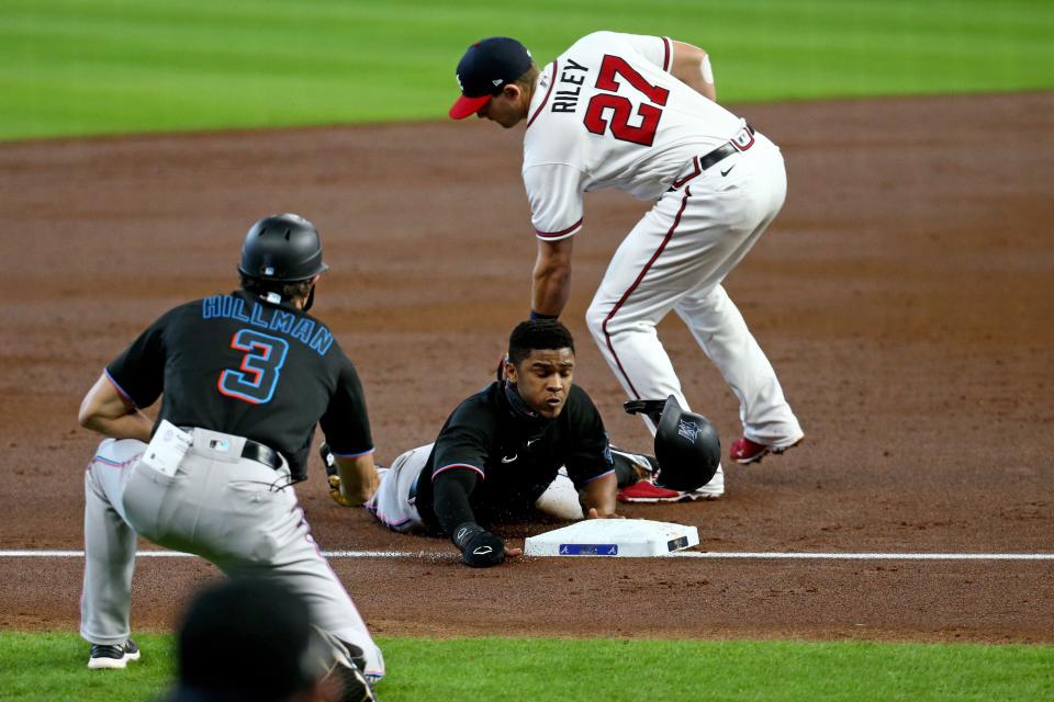 Miami's Magneuris Sierra slides safely into third base during the Marlins' 9-5 loss to the Atlanta Braves in Game 1 of their National League Division Series on Oct. 6, 2020. Sierra had two hits in the game.