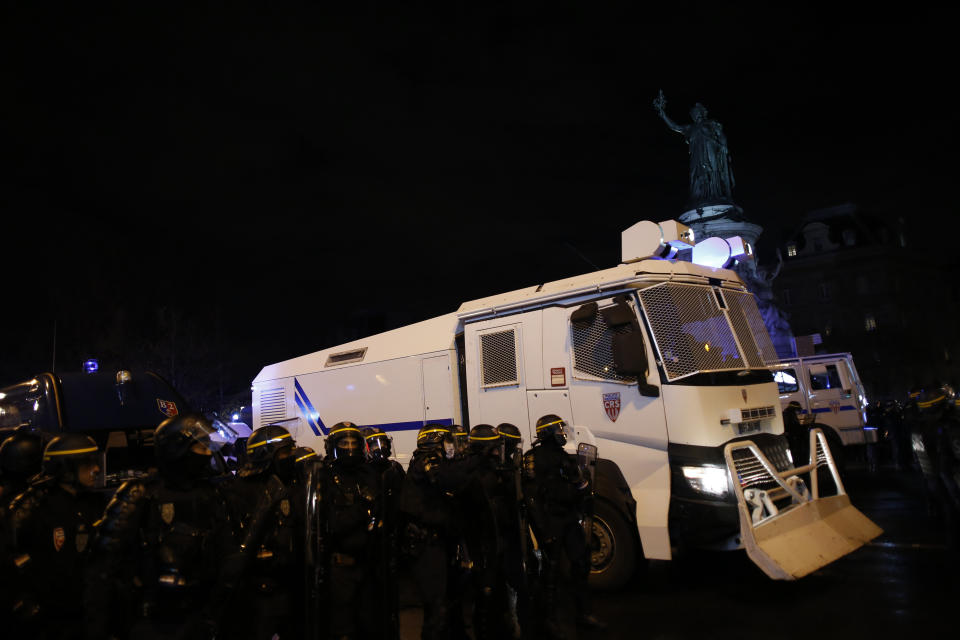 A police vehicle drives on the Place de la Republique after a protest against a proposed security bill, Saturday, Dec.12, 2020 in Paris. The bill's most contested measure could make it more difficult for people to film police officers. It aims to outlaw the publication of images with intent to cause harm to police. The provision has caused such an uproar that the government has decided to rewrite it. Critics fear the law could erode press freedom and make it more difficult to expose police brutality. (AP Photo/Thibault Camus)