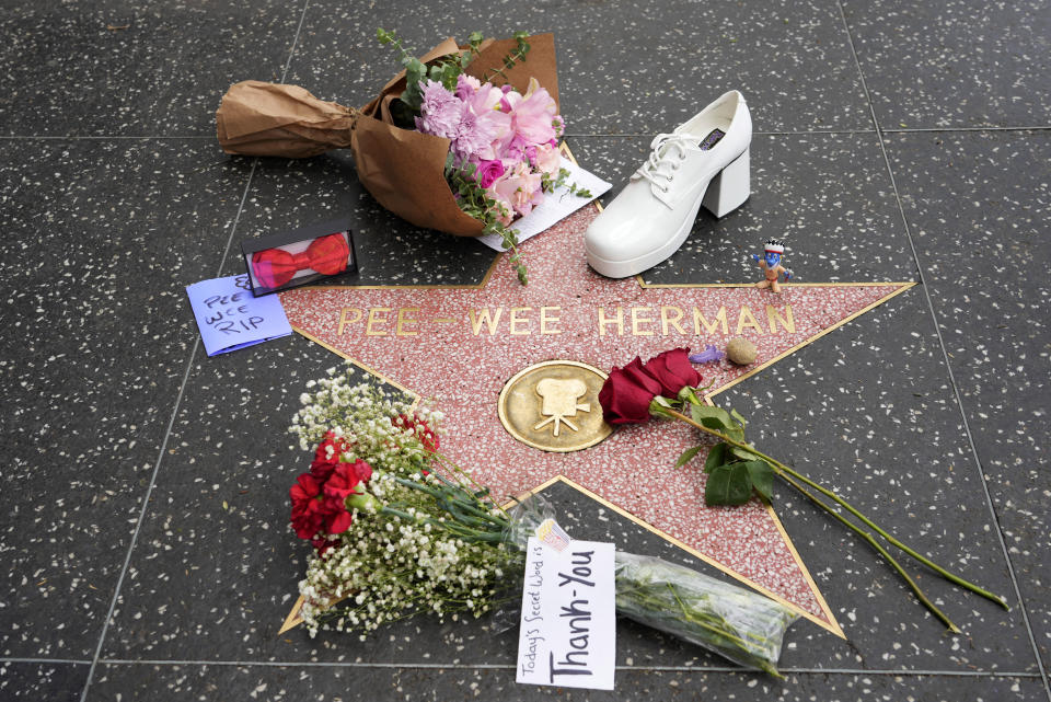 Flowers and mementos sit near the star of Pee-wee Herman on the Hollywood Walk of Fame, Monday, July 31, 2023, in Los Angeles. Paul Reubens, the actor and comedian who created the character, died Sunday night, July 30, after a six-year struggle with cancer. (AP Photo/Chris Pizzello)