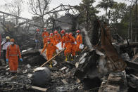 National Disaster Response Force rescuers carry the dead body of a person after an explosion and fire at a chemical factory in Dombivali near Mumbai, India, Friday, May 24, 2024. Multiple people were killed and dozens were injured in the incident that happened Thursday. (AP Photo/Rajanish Kakade)