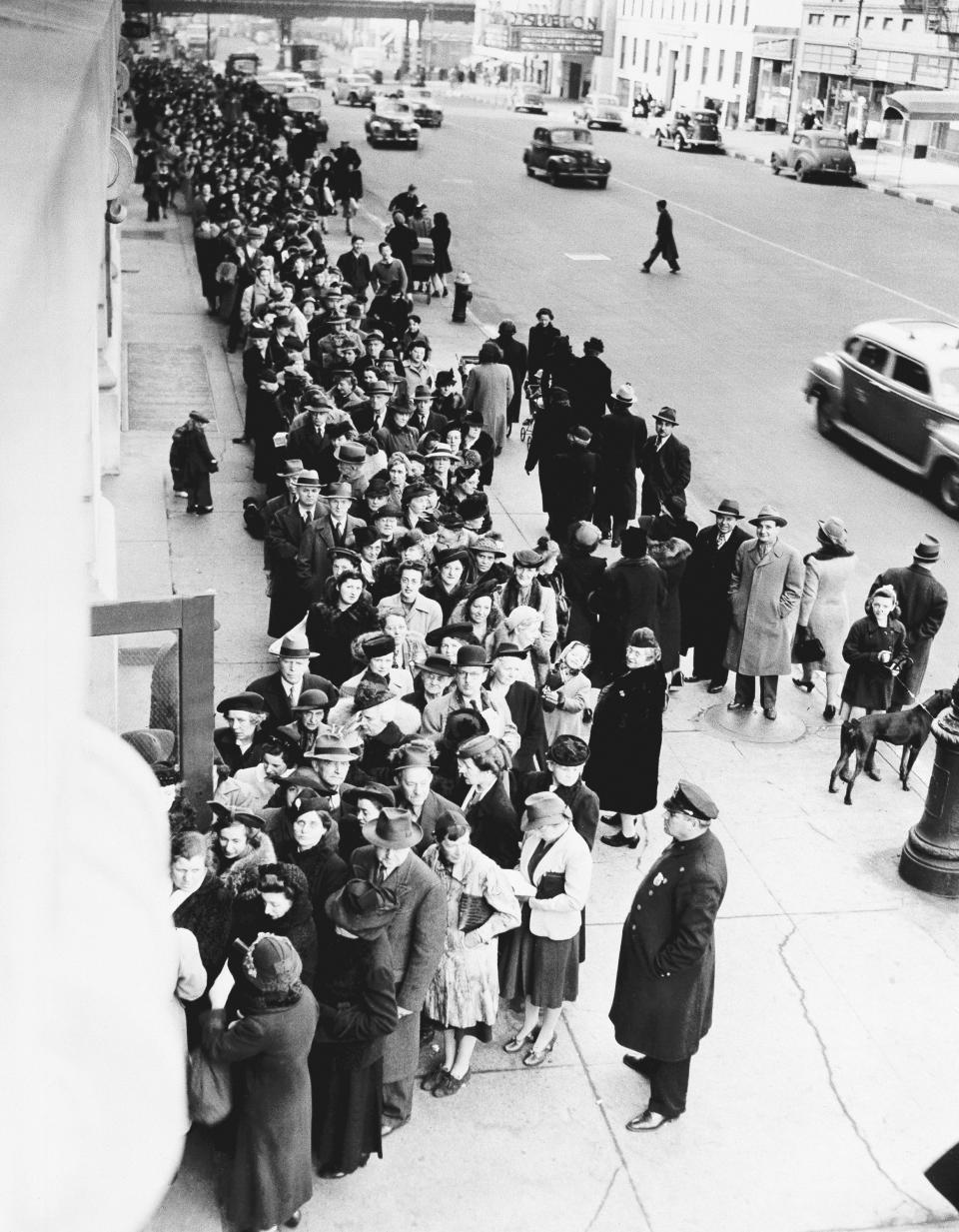 FILE - In this Feb. 23, 1943, file photo New Yorkers stand on long lines outside of schools all over the city to get their War Ration Book No. 2, during World War II. Not since World War II when people carried Ration Books with stamps that allowed them to purchase meat, sugar, butter, cooking oil and gasoline has the entire nation been asked to truly sacrifice for a greater good. (AP Photo, File)