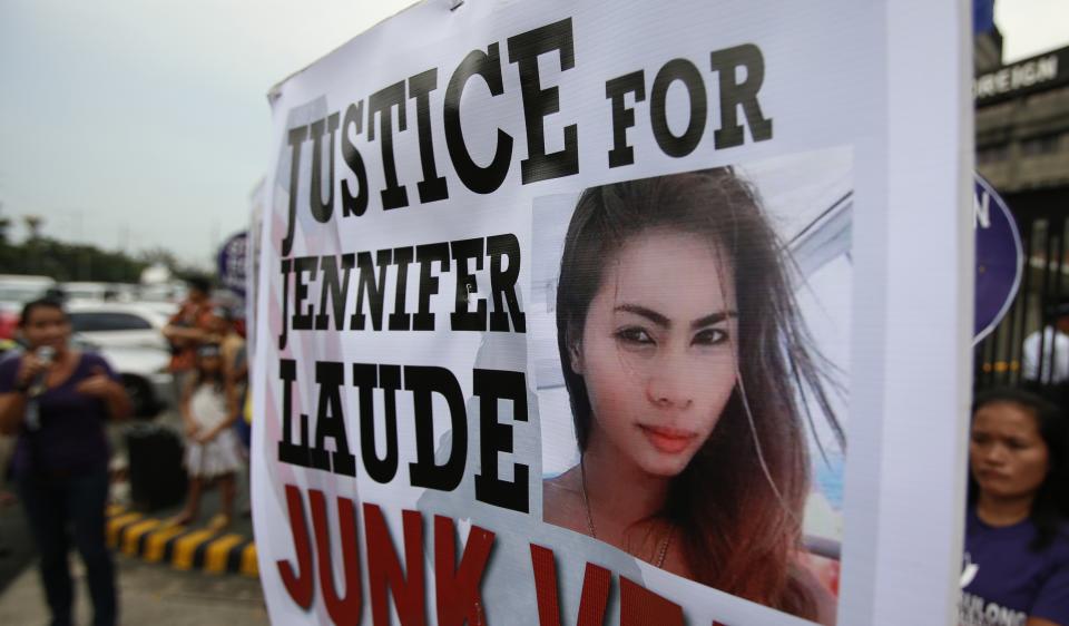 Protesters display a placard with a picture of slain 26-year-old Filipino transgender Jennifer Laude, during a rally outside the Department of Foreign Affairs in Manila October 15, 2014. The United States will keep custody of a Marine suspected in the murder of Jennifer Laude, whom he met in a bar, the head of the Philippine military said on Tuesday, and U.S. officials said a number of U.S. warships would remain in the country. REUTERS/Erik De Castro (PHILIPPINES - Tags: CRIME LAW POLITICS MILITARY)