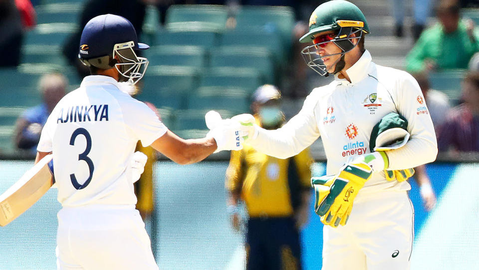 Tim Paine (pictured right) congratulates Ajinkya Rahane (pictured left) with a fist-bump.