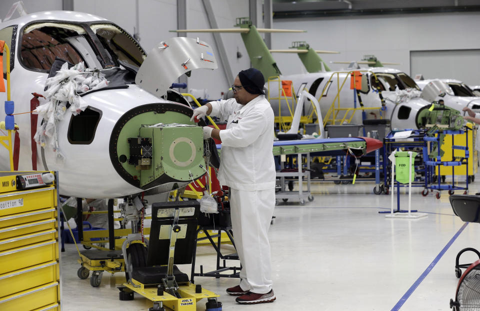 In this July 30, 2019, photo an employee works on an aircraft in the production area at the Honda Aircraft Co. headquarters in Greensboro, N.C. where the HondaJet Elite aircraft is manufactured. Nearly four years after delivering its first jet, Honda is facing decisions as the company better known for cars and lawnmowers considers whether to sink billions more into its decades-in-the-making aircraft division. (AP Photo/Gerry Broome)