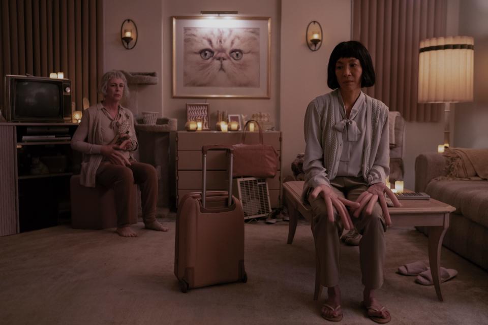 Evelyn (Michelle Yeoh, right, with Jamie Lee Curtis) experiences an alternate world where everyone has hot dogs for fingers in "Everything Everywhere All at Once."